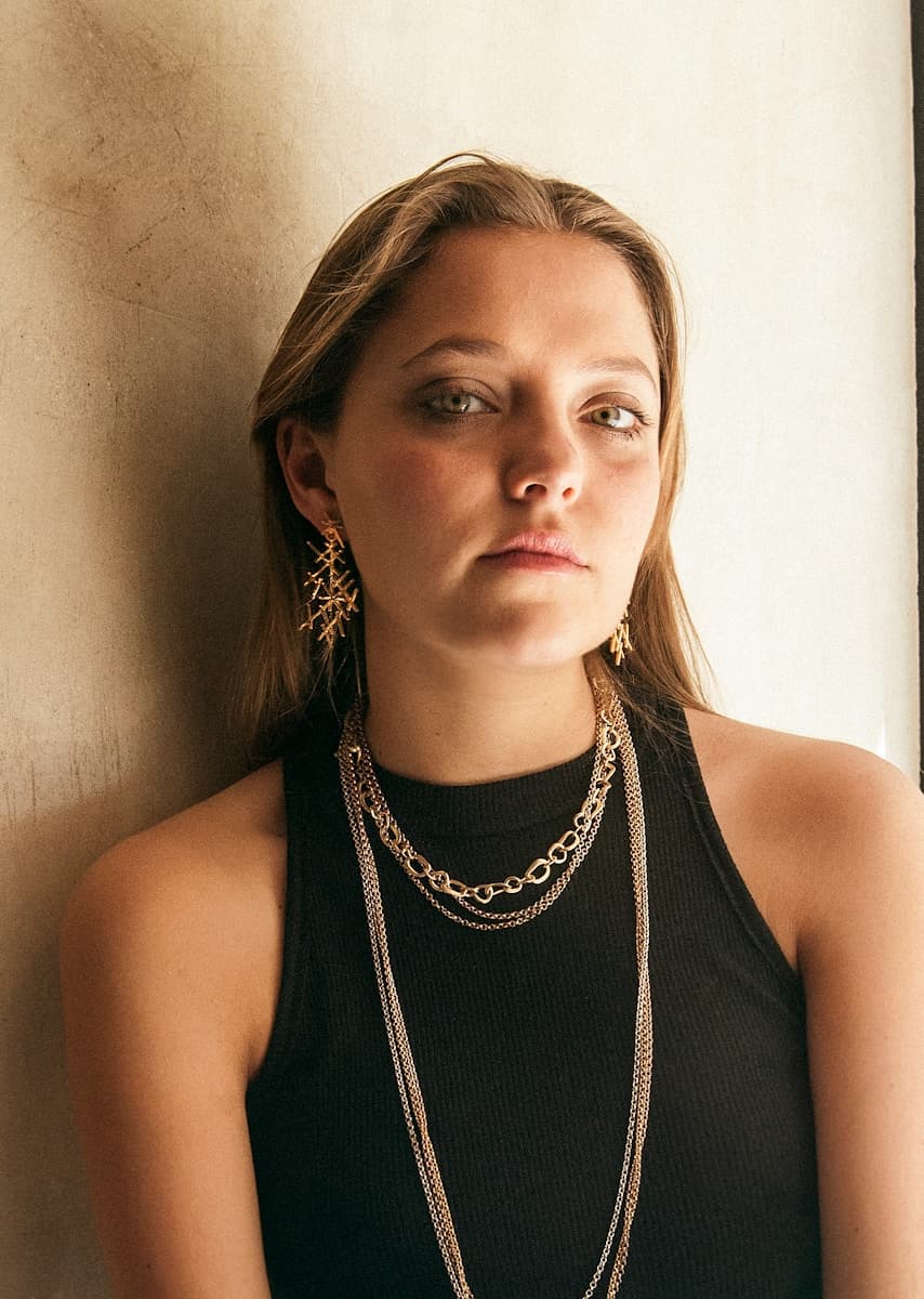 woman in black tank top wearing silver necklace