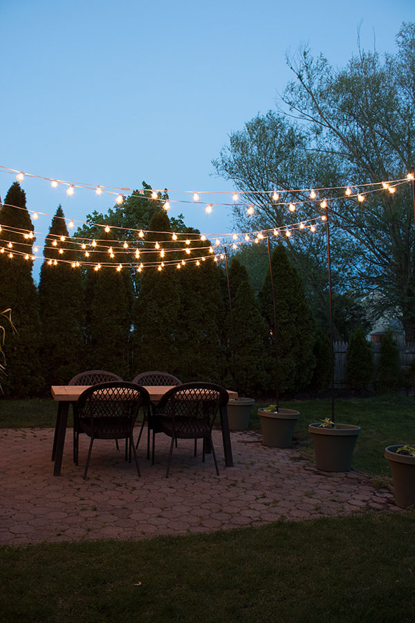 how to create a canopy of string lights over your patio or deck