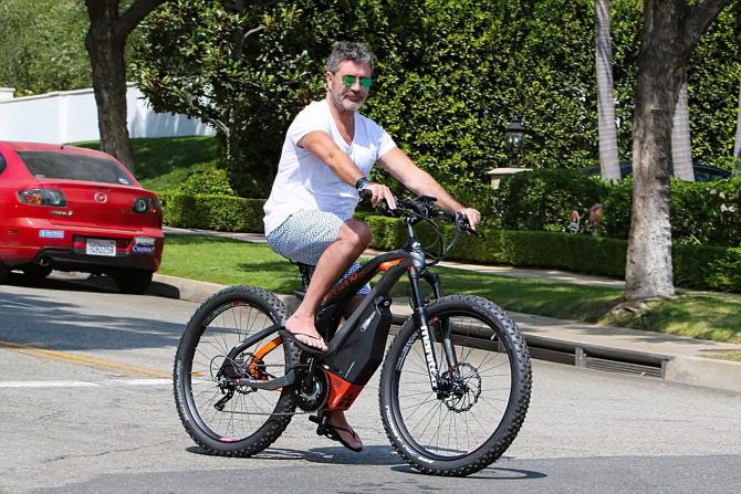 Simon Cowell riding a bike