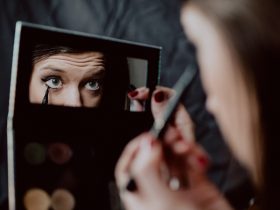 woman holding black framed mirror