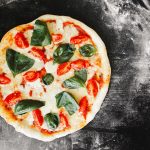 pizza with green leaf vegetable