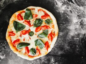 pizza with green leaf vegetable