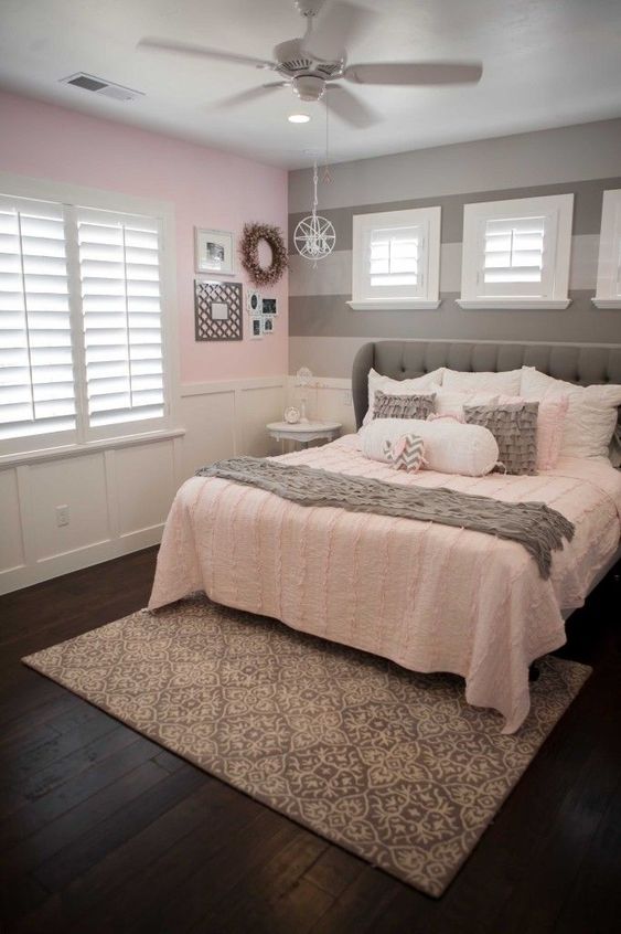 Bedroom With Gray Bed And pink Bedding, Gray Striped Accent Wall, And Pink Wall With White Panneling