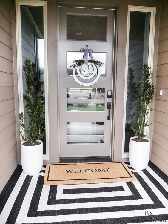 Black And White Outdoor Rug, Planters With Dwarf Trees And Minimalistic Wreath