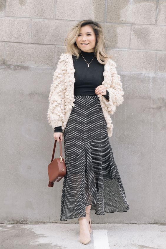 Black Turtleneck Blouse, Polkadot Maxi Skirt And Knitted Cardigan With Pom-poms