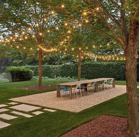 Center Yard Gravel Dining Patio, Path With Different Sized Pavers Sureounded By Trees