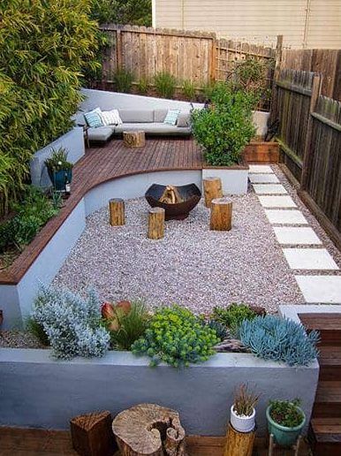 Gravel Patio With Fire Pit And Raised Wood Deck Sitting Area