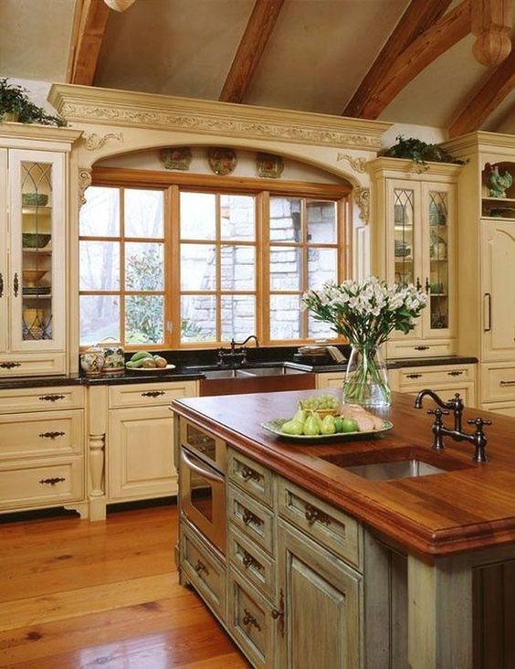 Ivory Country Style Cabinets With Black Countertops, Barnhouse Sink And Gray Kitchen Island With Wooden Countertop