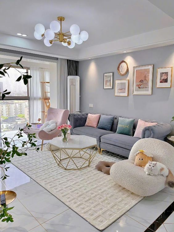 Living Room with Light Gray walls, Pink Furniture PIeces And White And Gold Accents