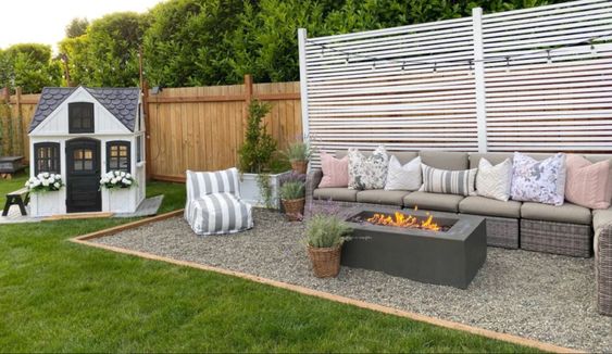 Pea Gravel Patio With Raised Concrete Fire Pit Outdoor Seating And Privacy Screen