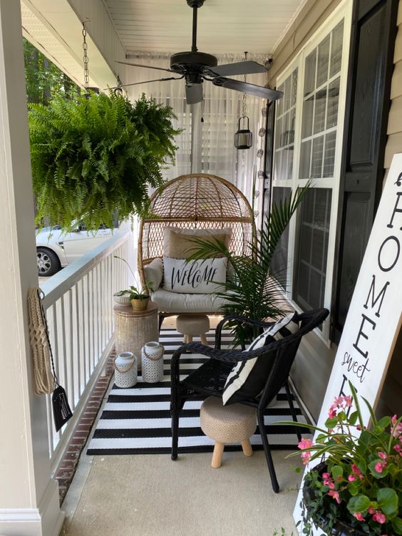 Porch Mat, Swinging Wicker Chair, Hanging Plants And Ceiling Fan