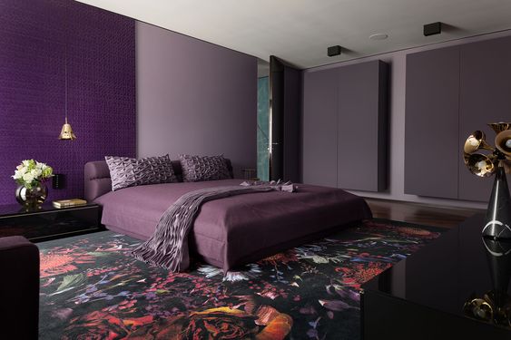 Purple Bedroom With Purple Paneling And Dark Floral CArpet