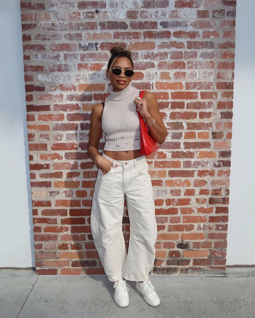 Sleevles Turtle Neck Crop Top With White Barrel Jeans And Sneakers