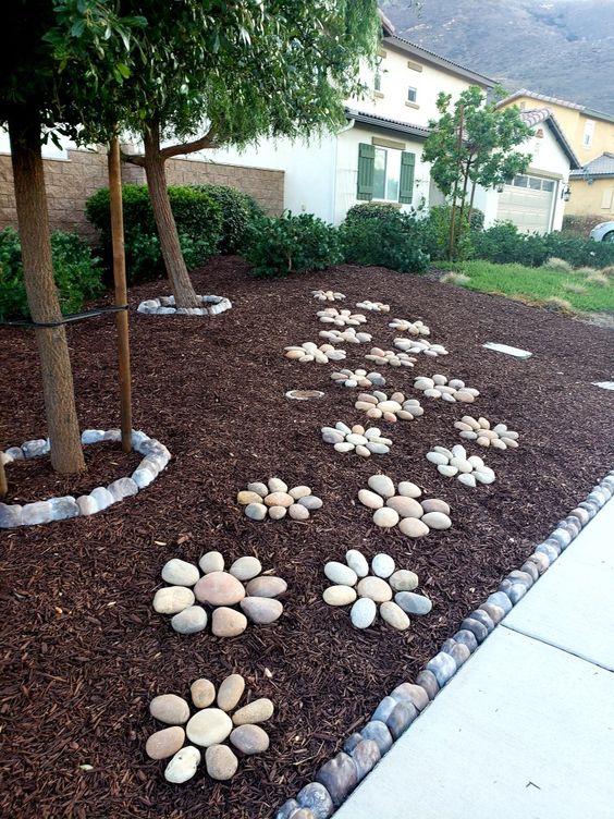 Stone Flowers Decor On Slanted Mulch Front Yard