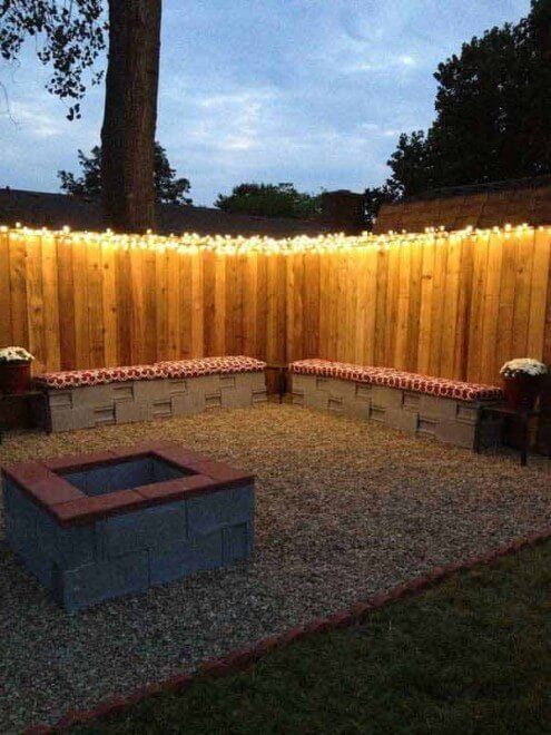 String Light On fence With Cinder Block Benches And Firepit