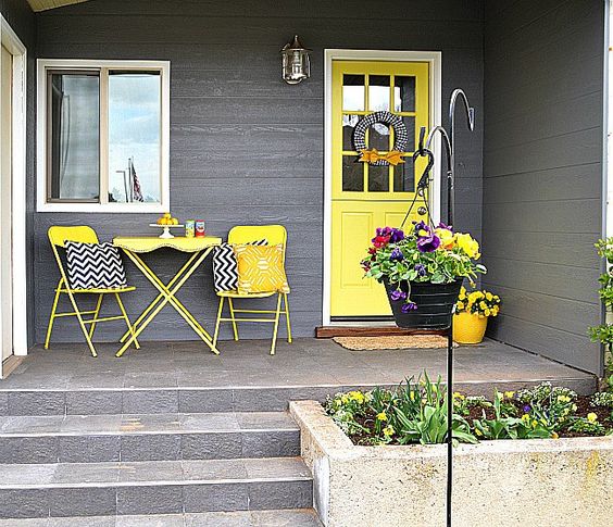 Yellow Door, Yellow Folding Chairs And Table And Concrete Flower Bed