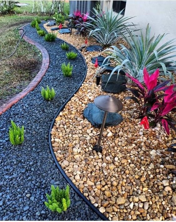 Black Pebble Edge Garden With Black Rocks Over Orange Pebbles