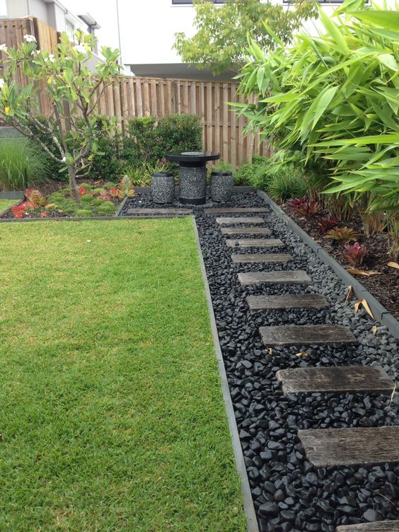 Black Rivver Rocs And Concrete Steps Pathway Along The Fence