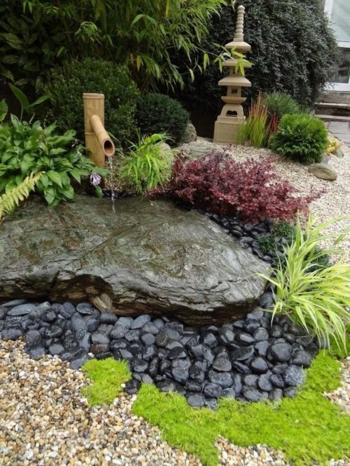 Japanese Garden Design With Large Black Fatstone, Black Pebbles And Bamboo Water Feature