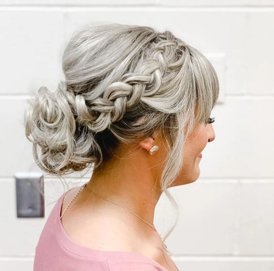 Low Messy Bun With Side Dutch Braid And Bangs