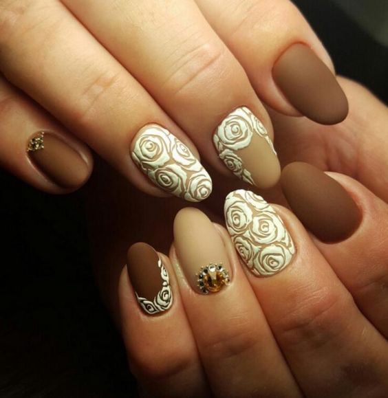 Short Brown And Baige Oval Nails With White Rose Design