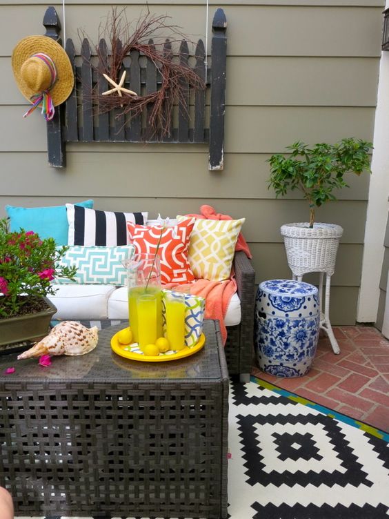 Wicker Porch Bench With Colorful Flowers And Beach Wall Decor