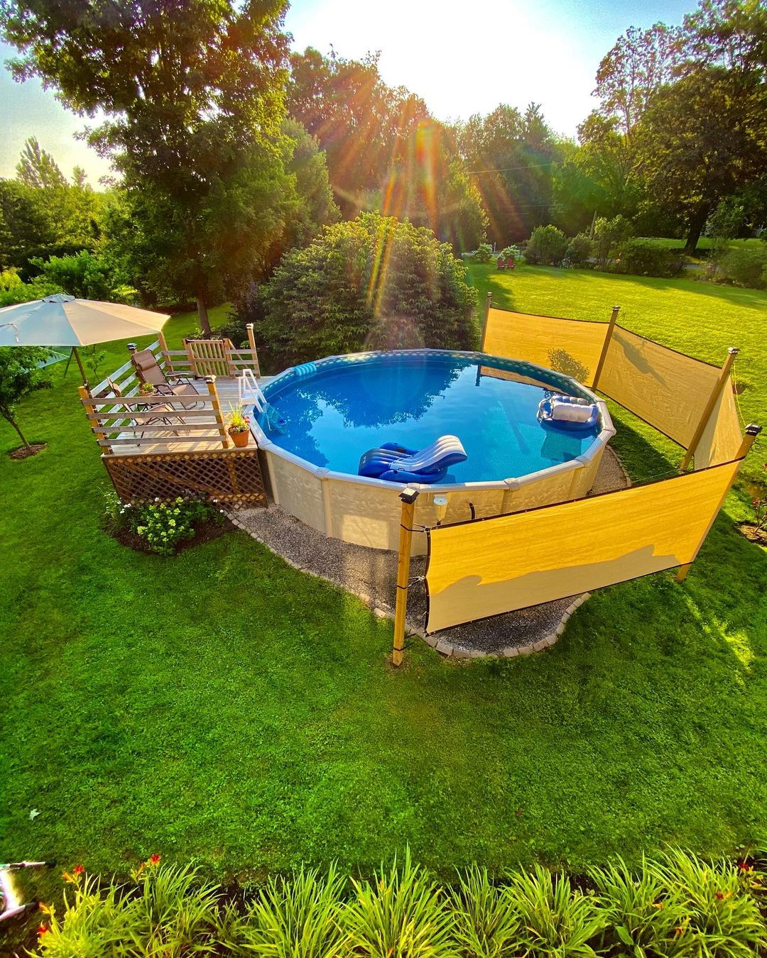 Above-ground Pool With Small Raised Deck And Canvas Privacy Screen
