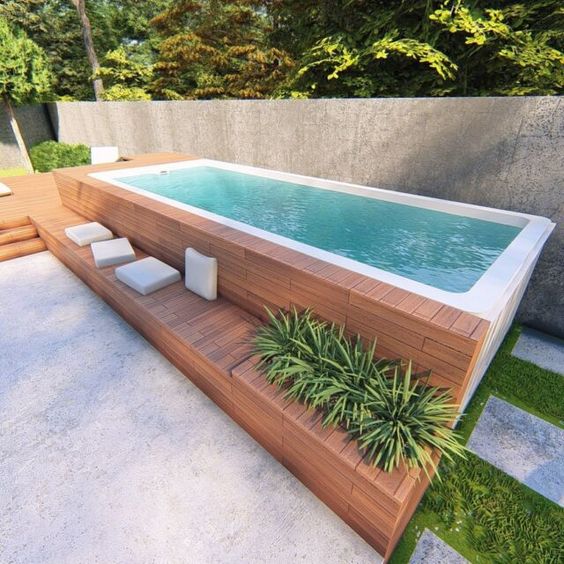 Square Above-ground Pool Nect To Wall With Bild In Bench And Planter