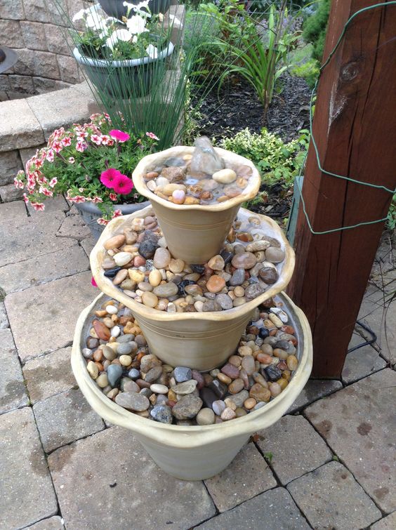 Staacked Planters With Pebbles Fountain