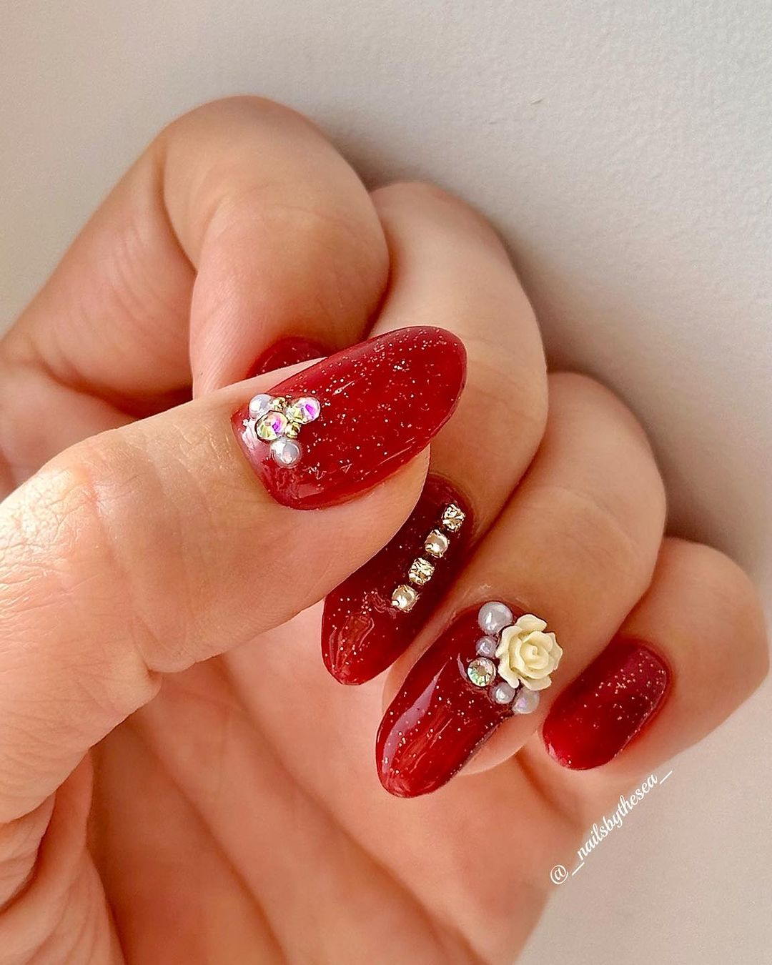 Glitter Red Nails With 3D Rhinetones And Flowers