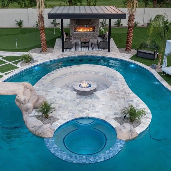 Lazy River Pool With Paved Island with Fire Pit And Seating Area With Fireplace