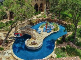 Lazy River Pool With Small Island And Hot Tub and Rock Waterfall Feature