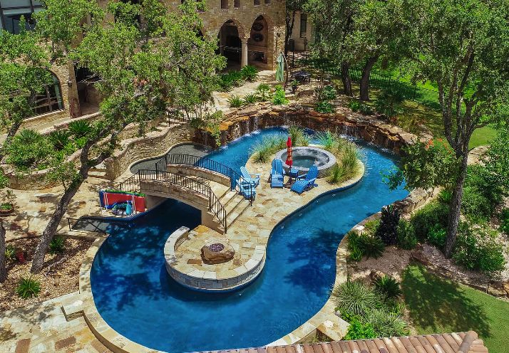 Lazy River Pool With Small Island And Hot Tub and Rock Waterfall Feature