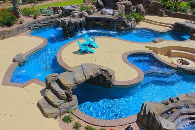 Lazy River Pool With Stone Slat Bridge, Paved Island, Fire Pit And FOuntain