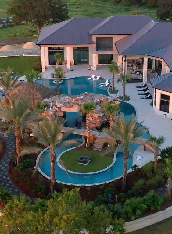 Lazy River Pool With Tropical Landscape, Connecting BRidge And Raised Island