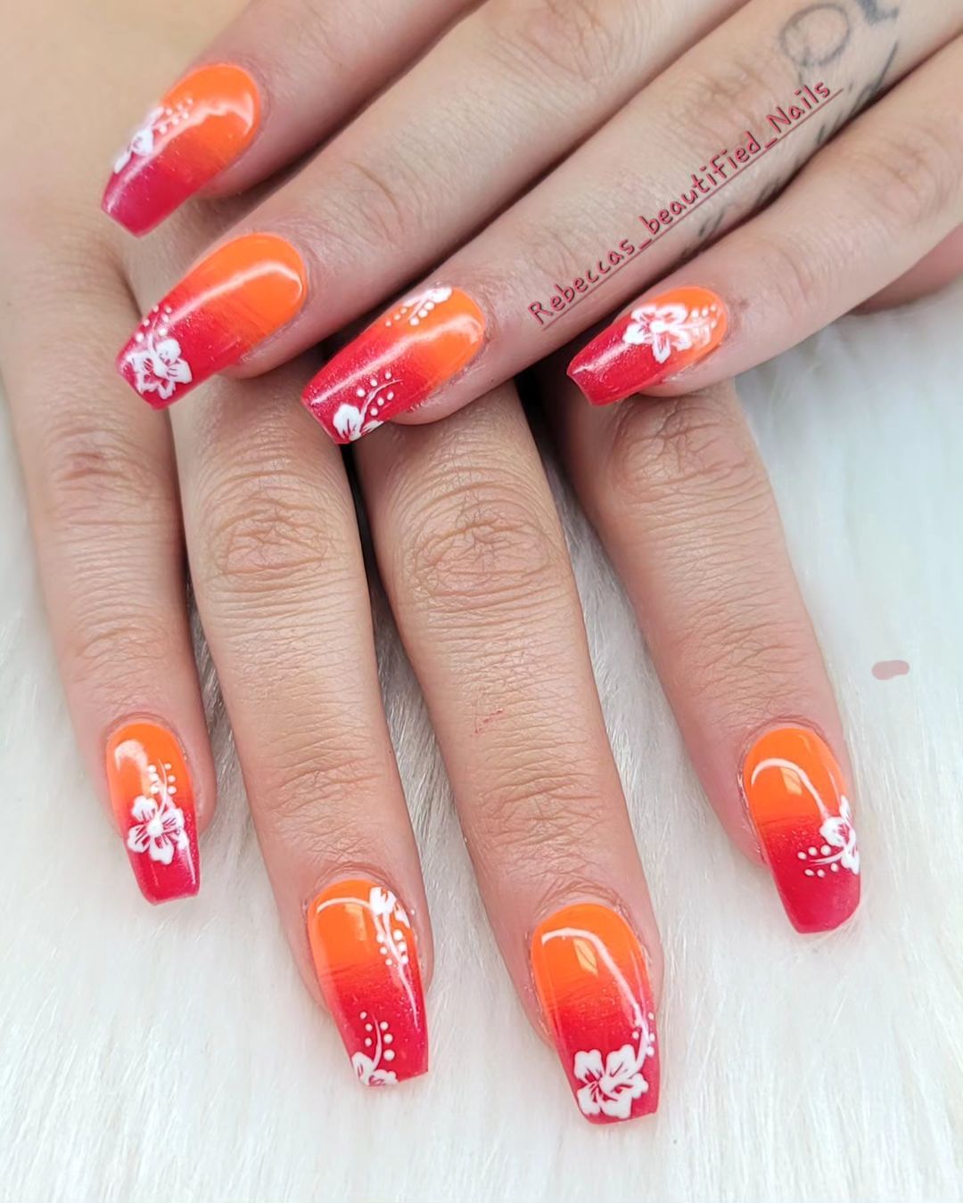 Red And Orange Sequoval Nails With White Hibiscus