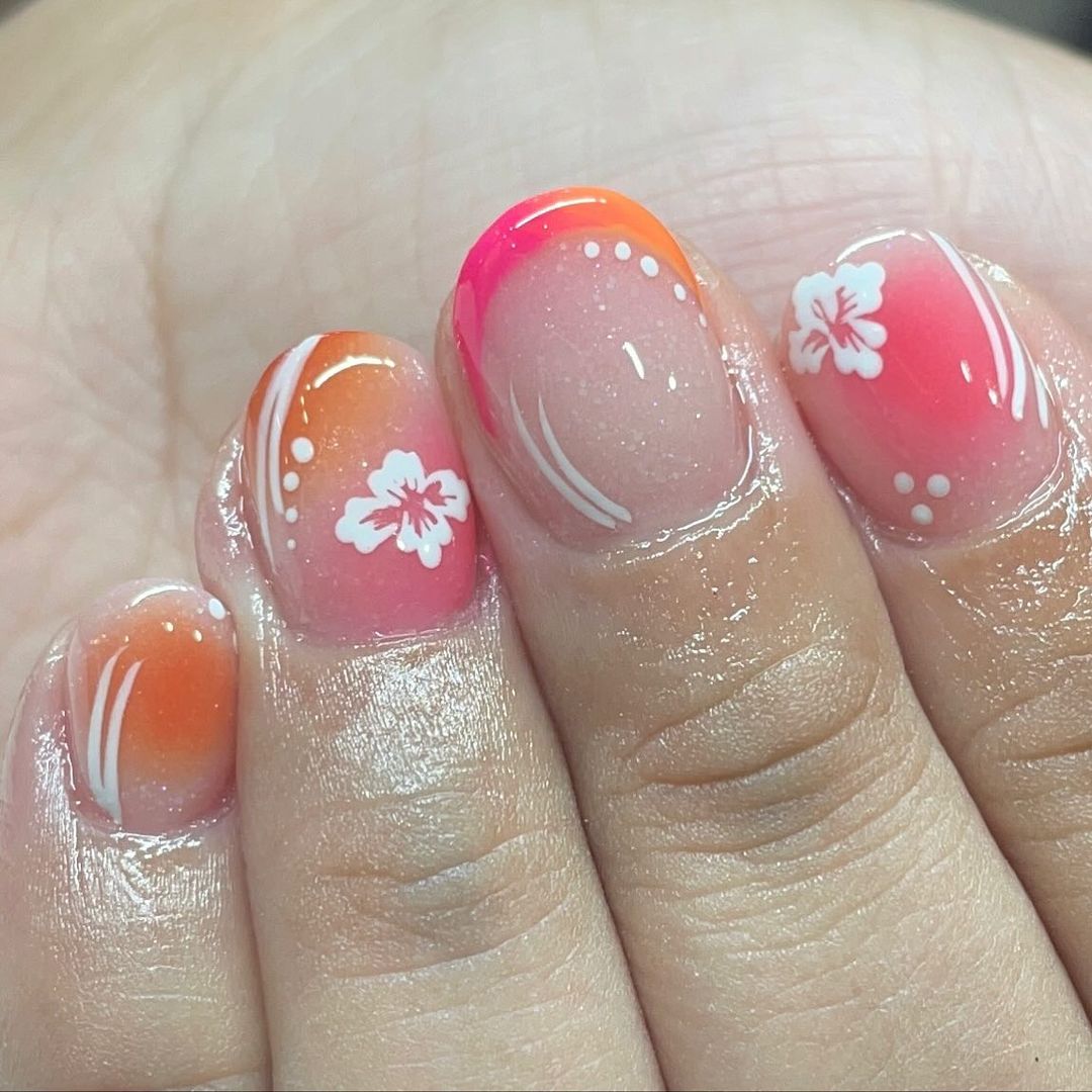 Short Clear Sparkle Nails With Orange and pink Tips And White Flower