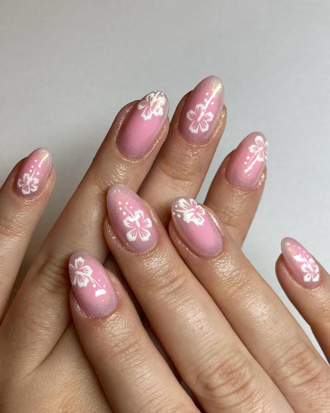 Short Oval Pink Nails With Hibiscus Design