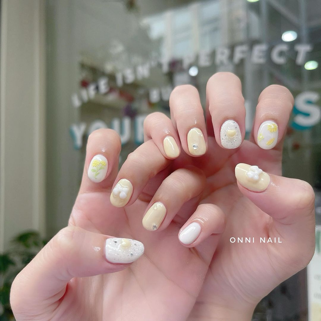 Yellow and White Nails With 3D Floral Details