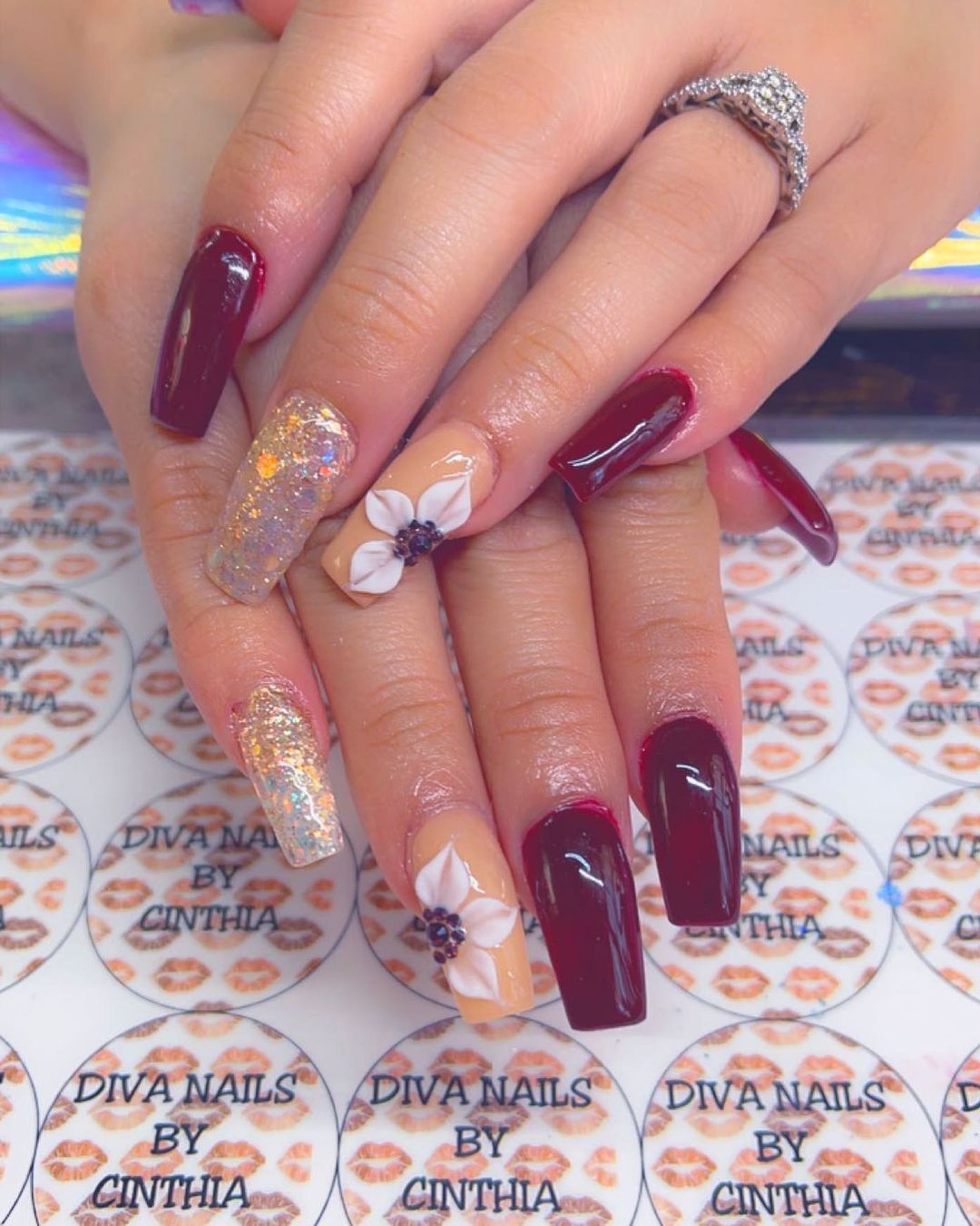 Burgundy And Orange Nails Wth Glitter And Floral Design