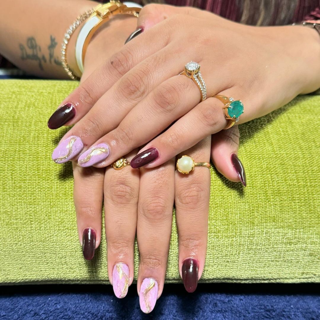 Burgundy With Marbeled Pink And Gold Nails