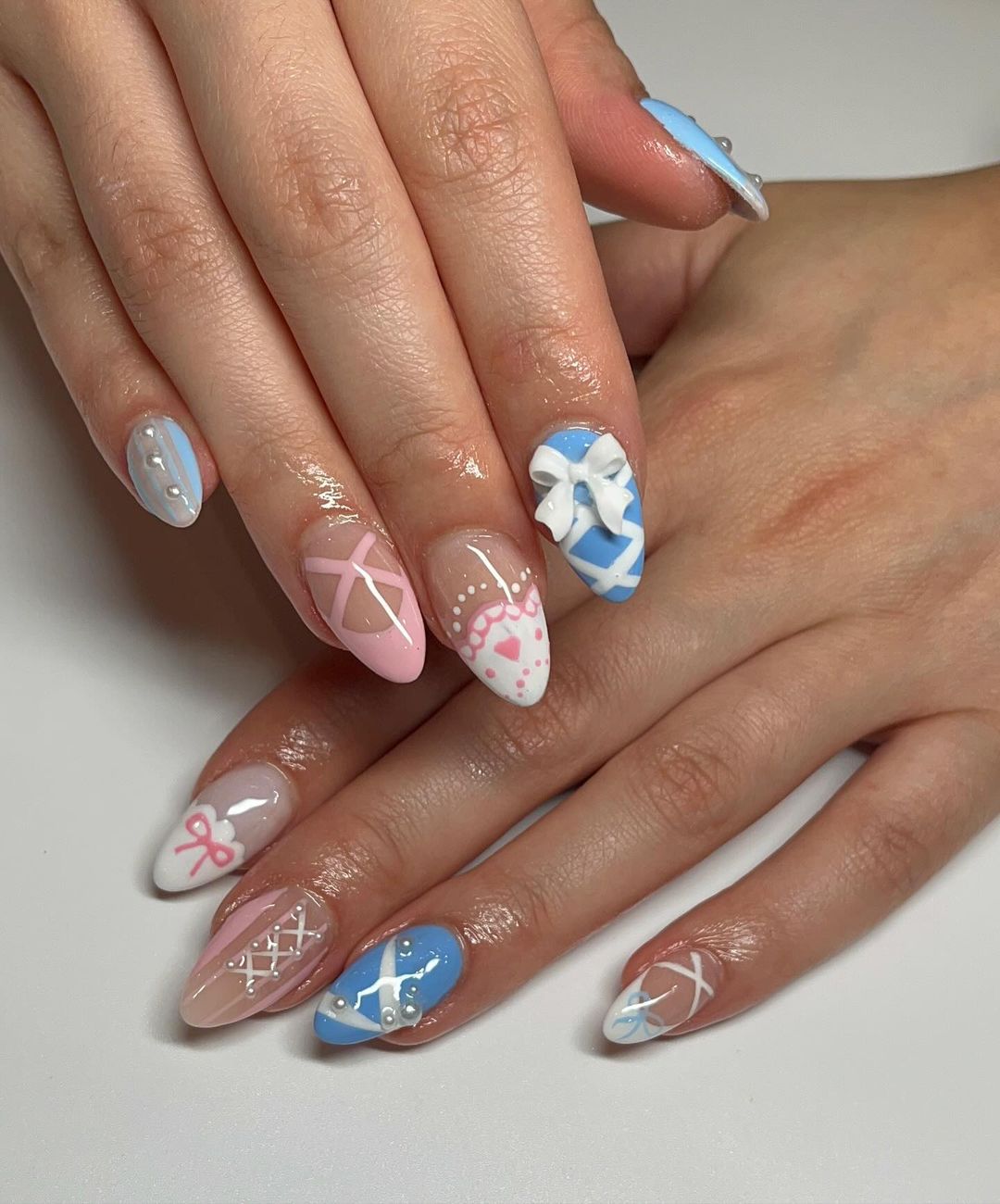 Pink, Blue and White Almond Nails With Bow And Lace Design