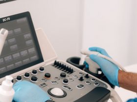 a person in blue gloves is operating a machine