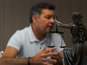 A man sitting at a table in front of a statue